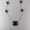 Art Deco pendant necklace, amethyst glass with floral bezel j-NLAD991