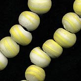 Vintage Czech flattened sandcast white and yellow rounds. 8 x 10 mm to 12 x 14 mm.  Pkg of 8.